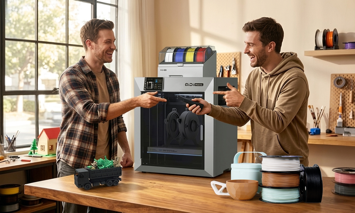 Two creators discuss 3D print next to QIDI multicolor 3D printer in sunlit workshop with filament and tools