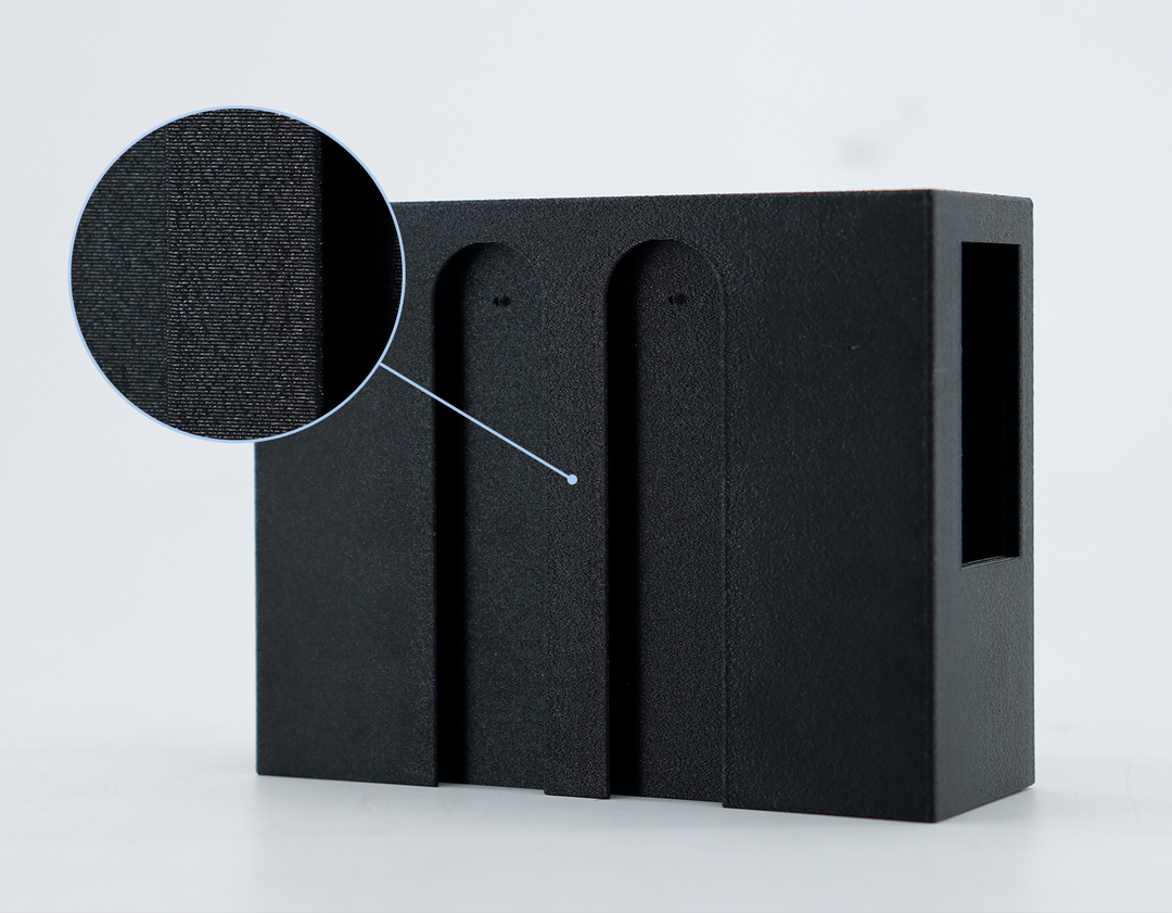 Black PETG-CF filament with a magnified view showing its matte, textured surface and carbon fiber composite structure.