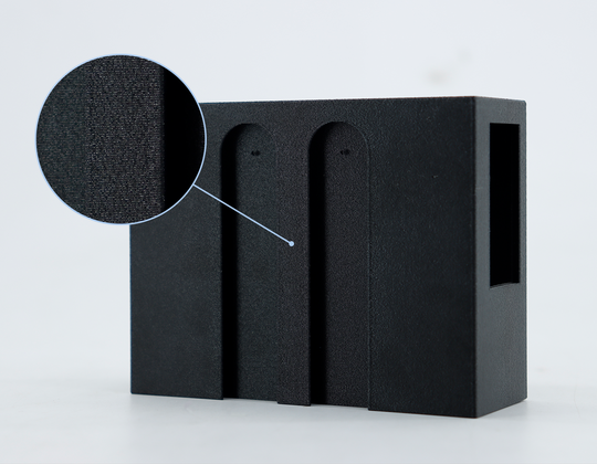 Black PETG-CF filament with a magnified view showing its matte, textured surface and carbon fiber composite structure.
