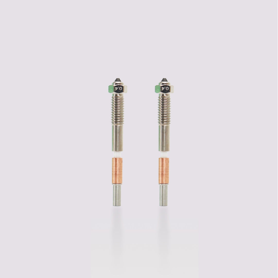 Two QIDI Tech Plus4 bimetal nozzles, 0.4mm, with silver and copper components. Ideal for 3D printing upgrades.